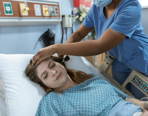 Woman lying in hospital bed