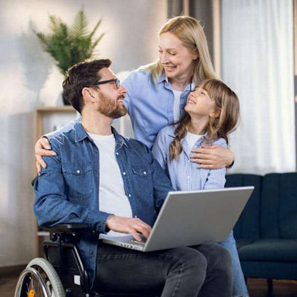 Man in wheelchair with woman and child
